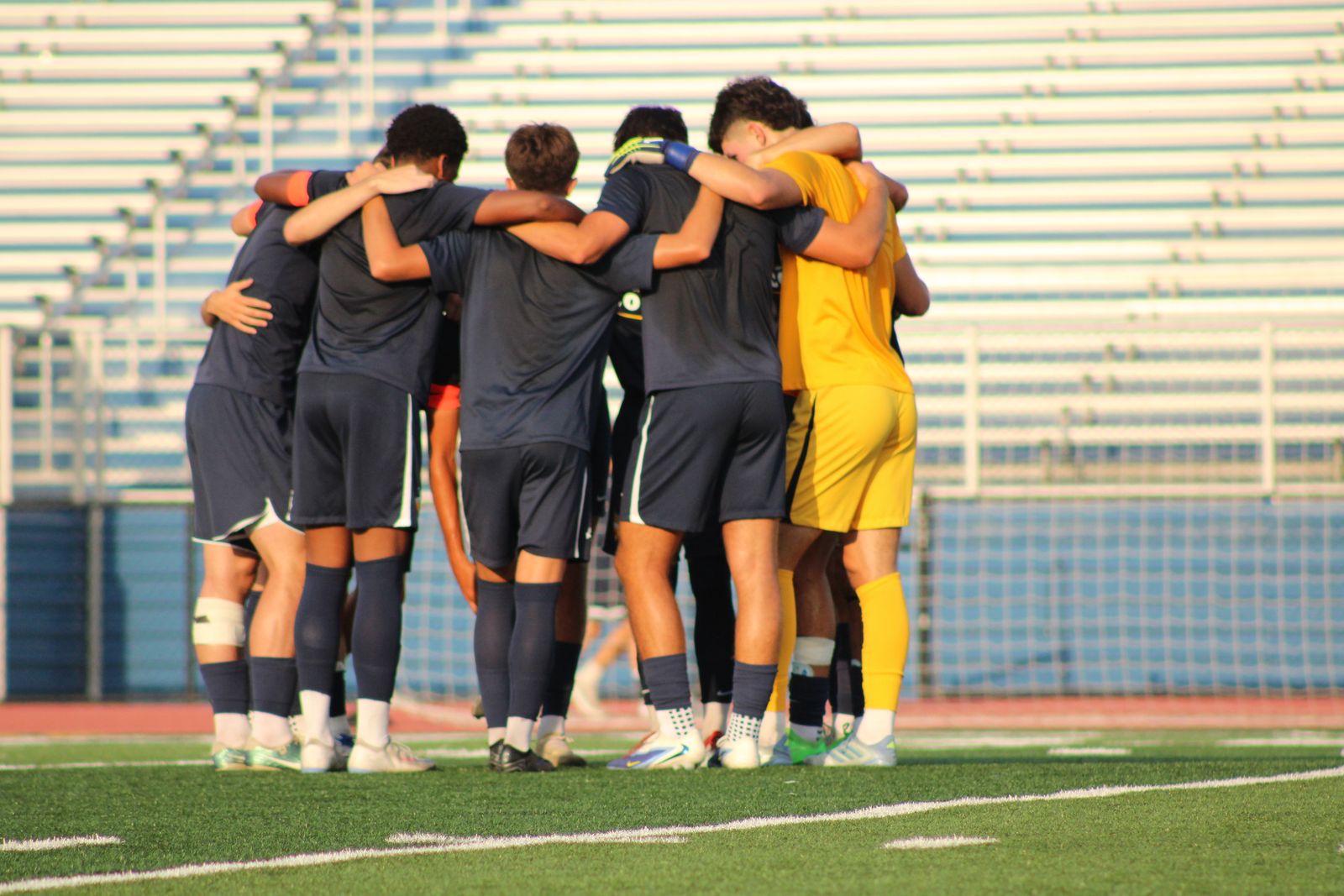 St. Ignatius Wildcats players walking onto the pitch at golden hour